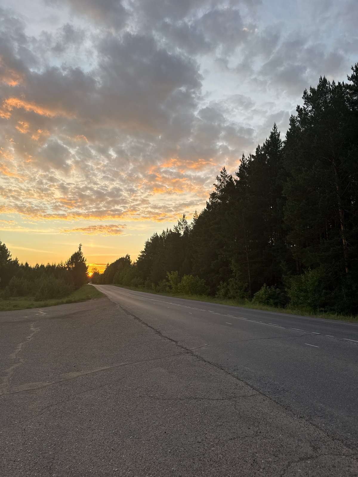 Dramatic sunset captured along rural roads in Камское, Russia