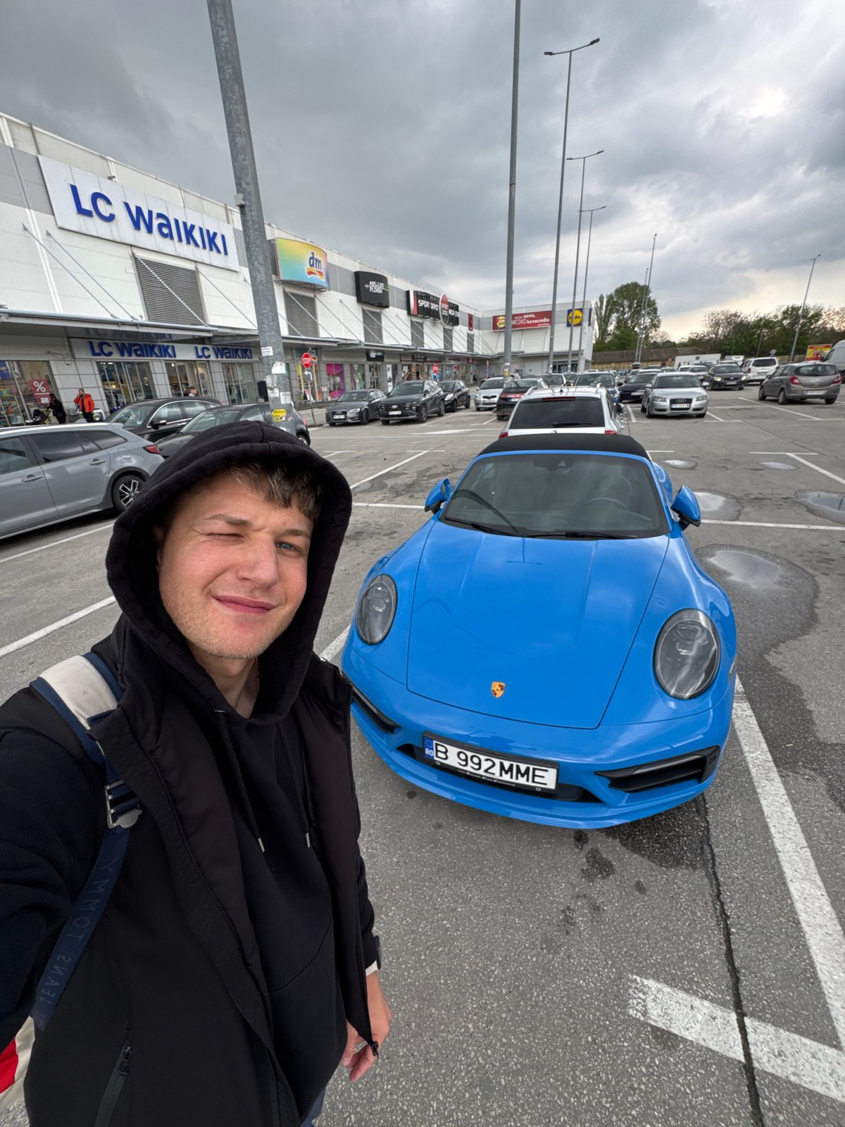 Tourist documents luxury cars during Plovdiv shopping center visit