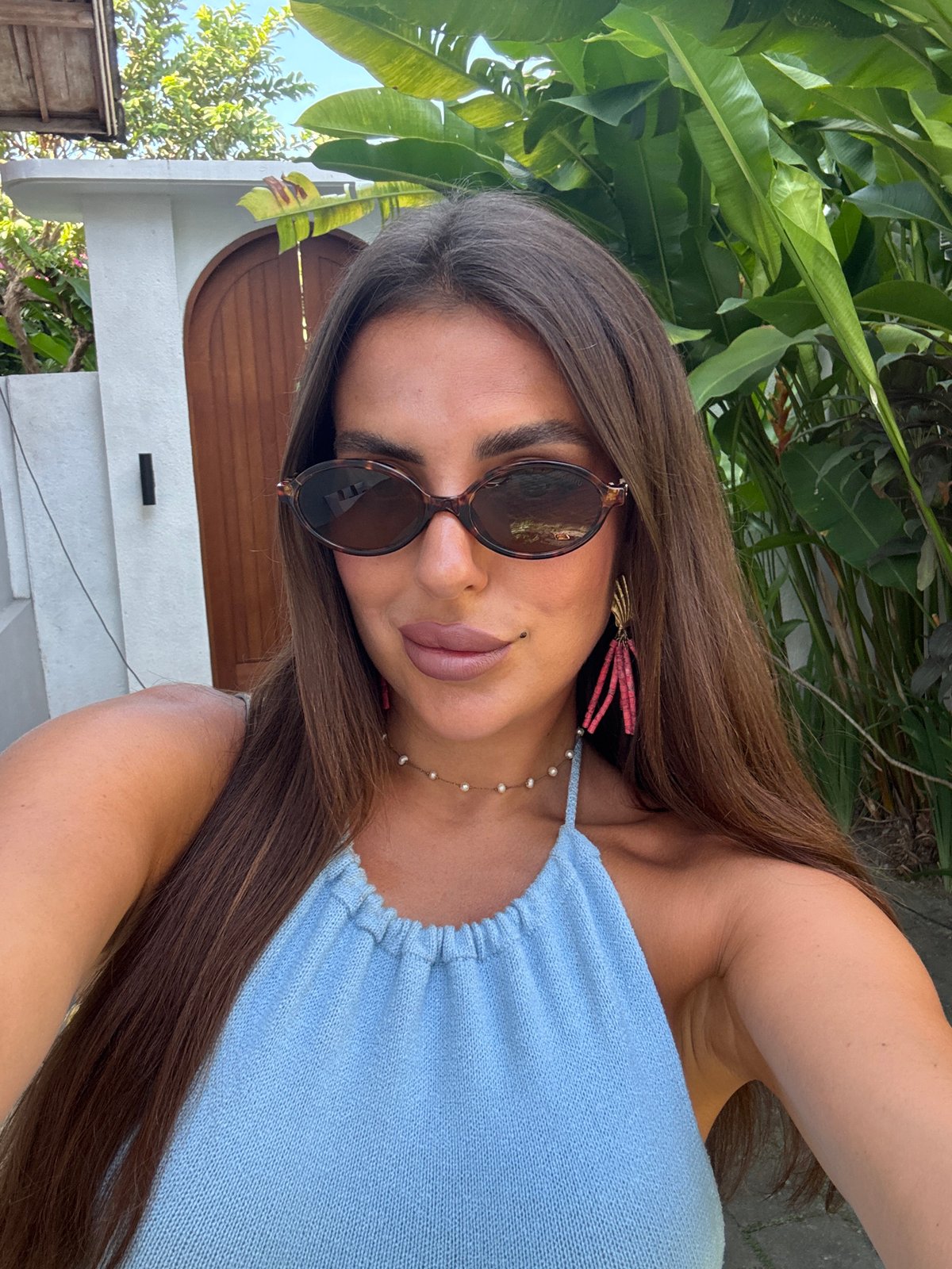 Woman takes selfies in tropical North Kuta setting