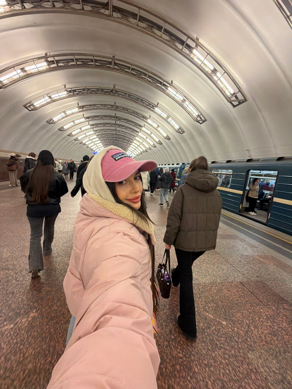 Woman takes selfie on Saint Petersburg subway train