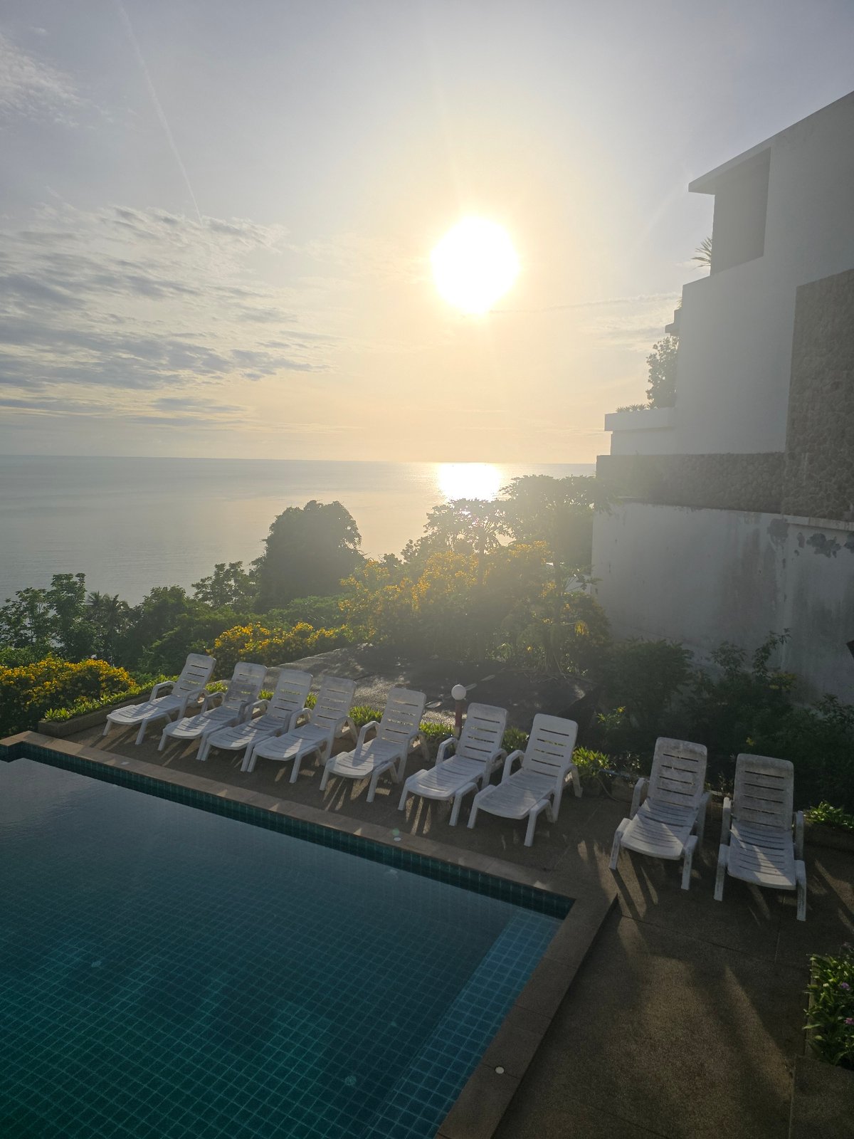 Infinity pool overlooking the ocean, golden light, no one around