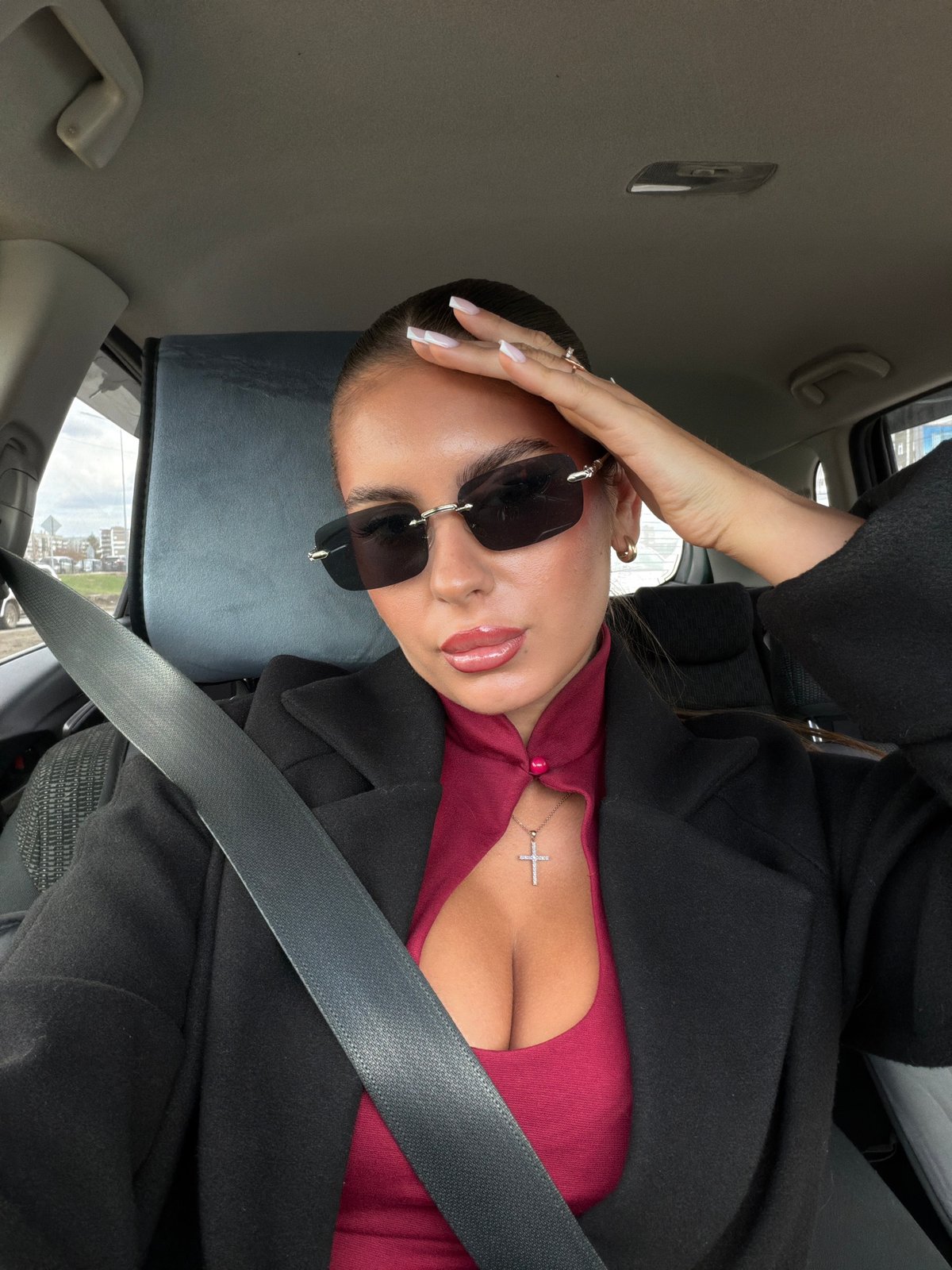 Woman poses for photo inside car in Krasnoyarsk