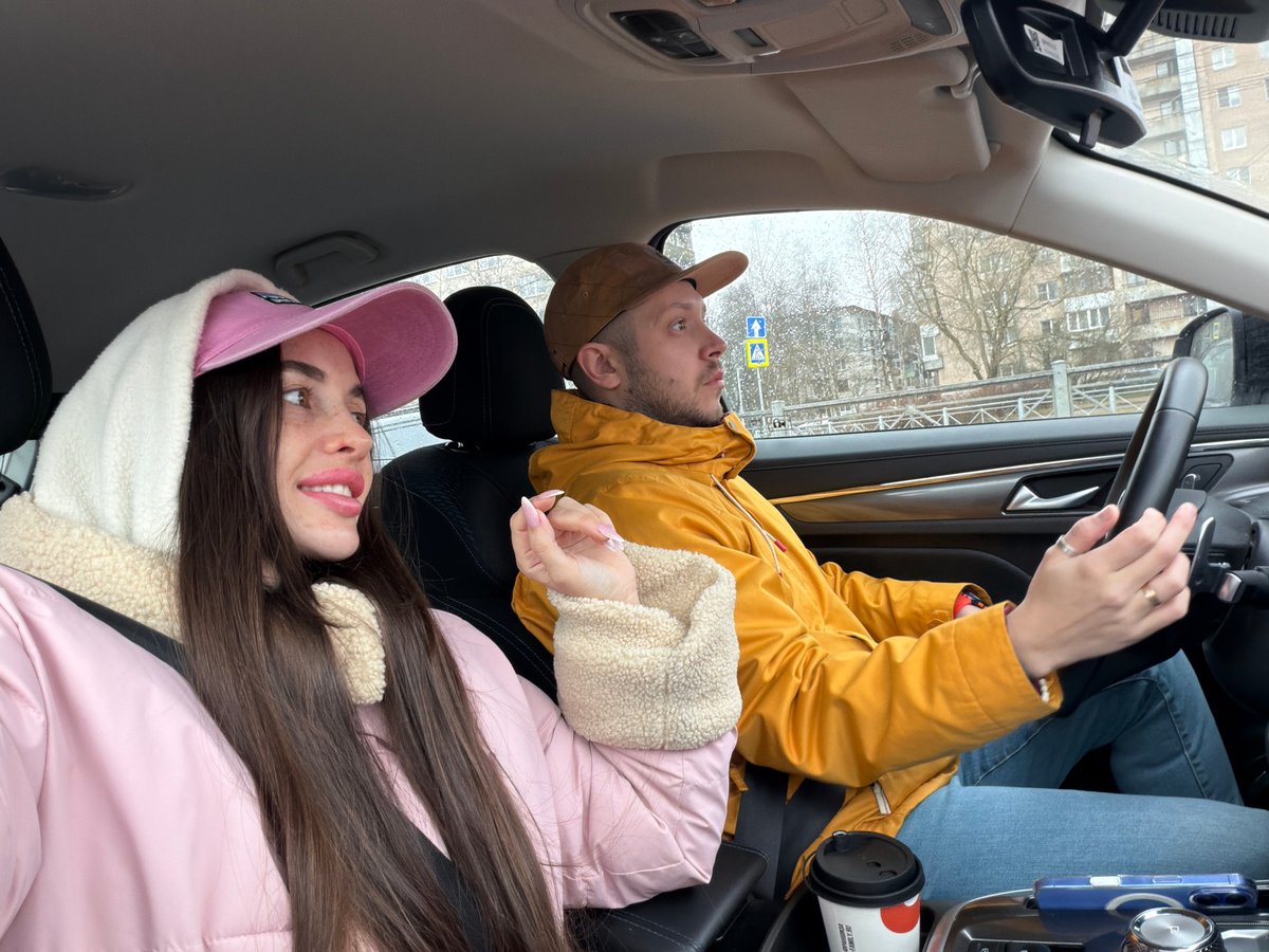 Couple drives through rainy morning traffic in Saint Petersburg