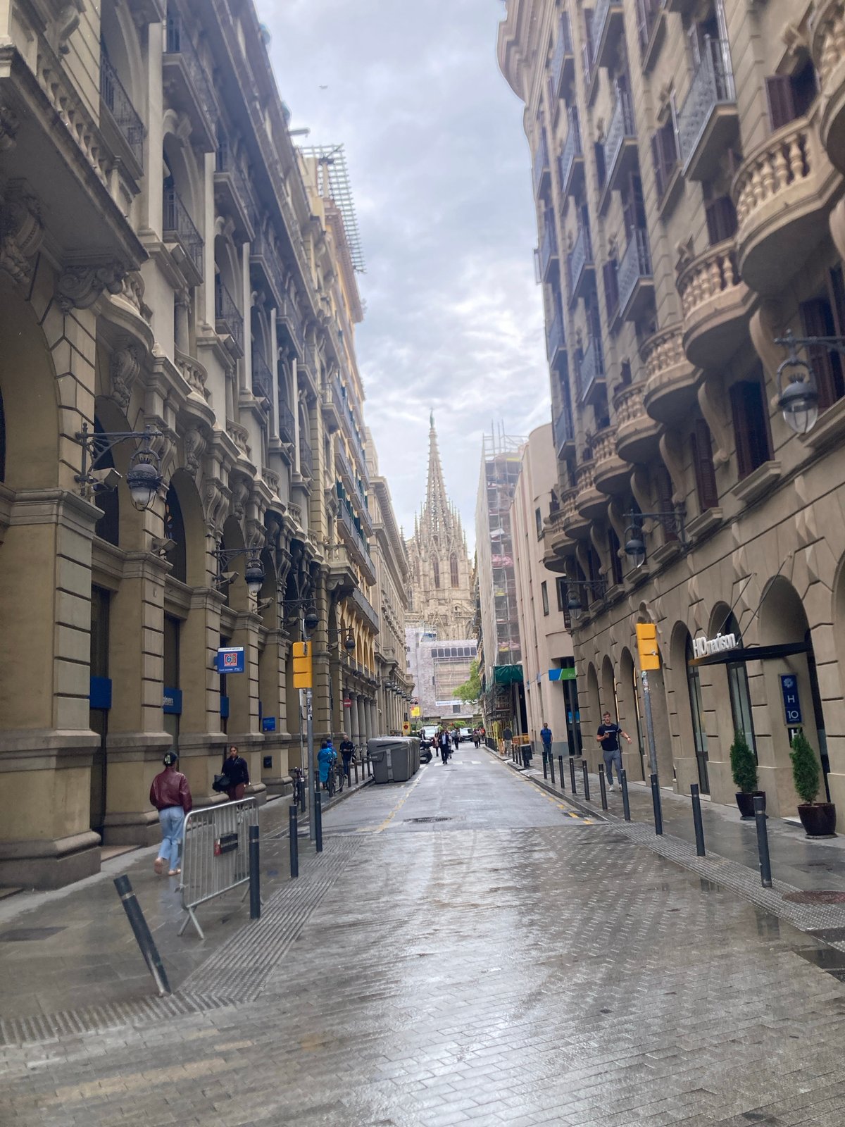 Wet streets and classical architecture observed in Barcelona