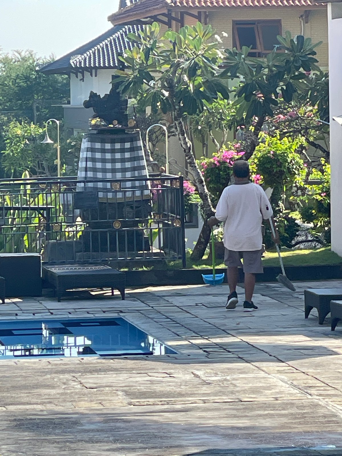 Early morning poolside activities at Kuta Selatan resort facility