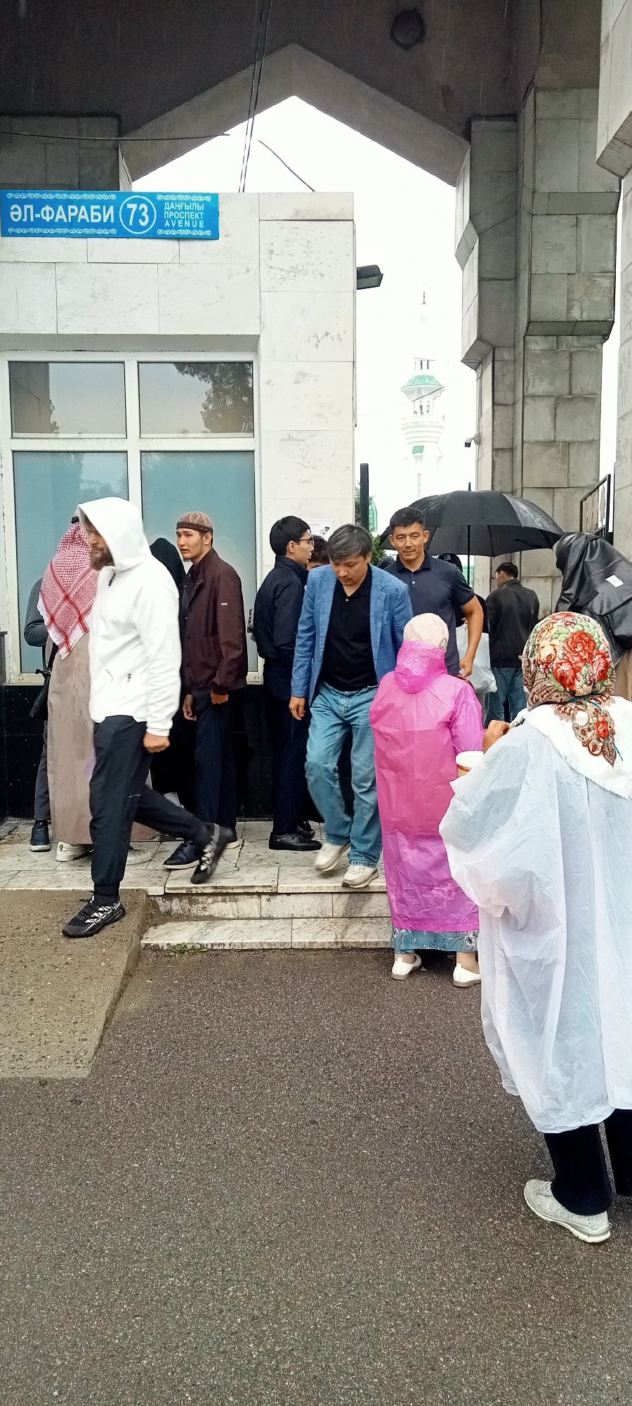 Rainy morning gathering at Almaty's Central Mosque