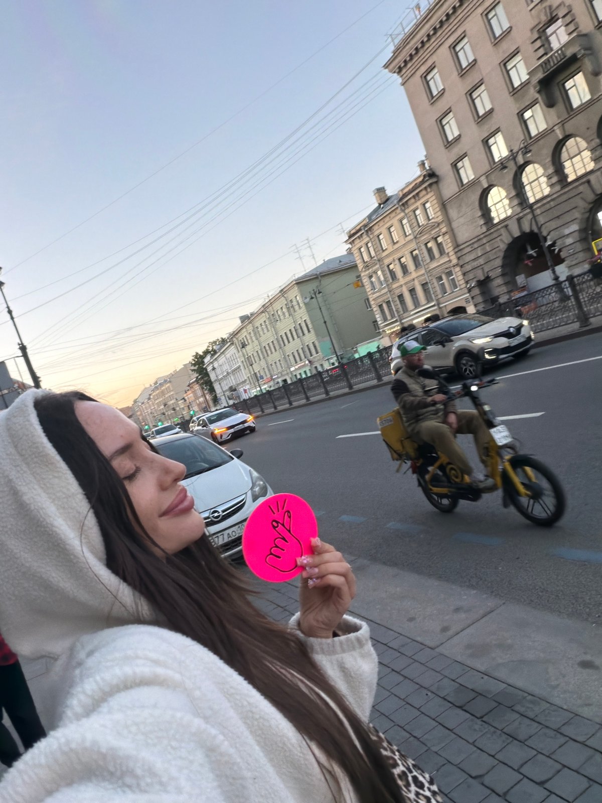 Woman takes selfie on Saint Petersburg street Friday evening