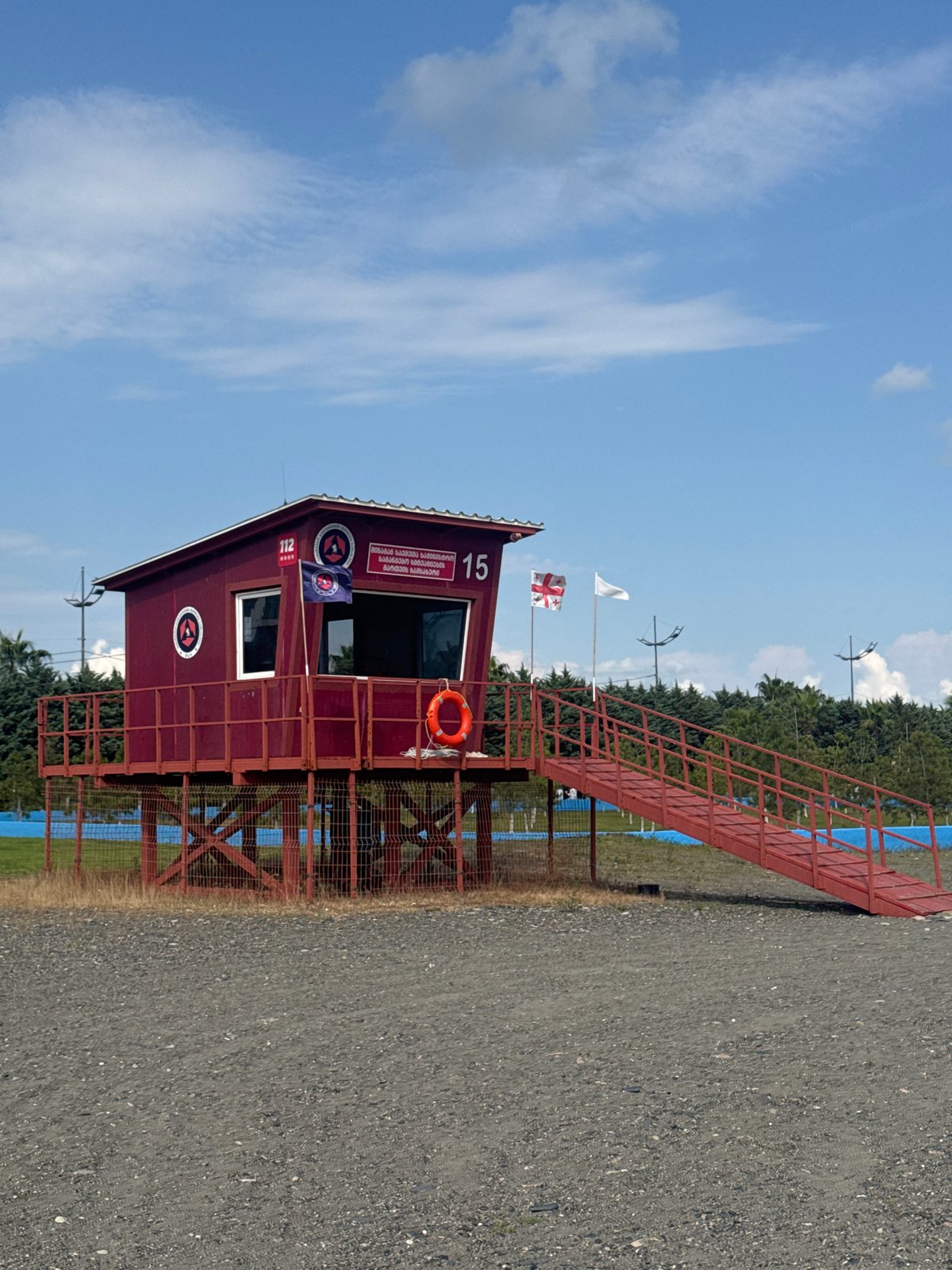 Red lifeguard station on stilts at Anaklia's pebble beach