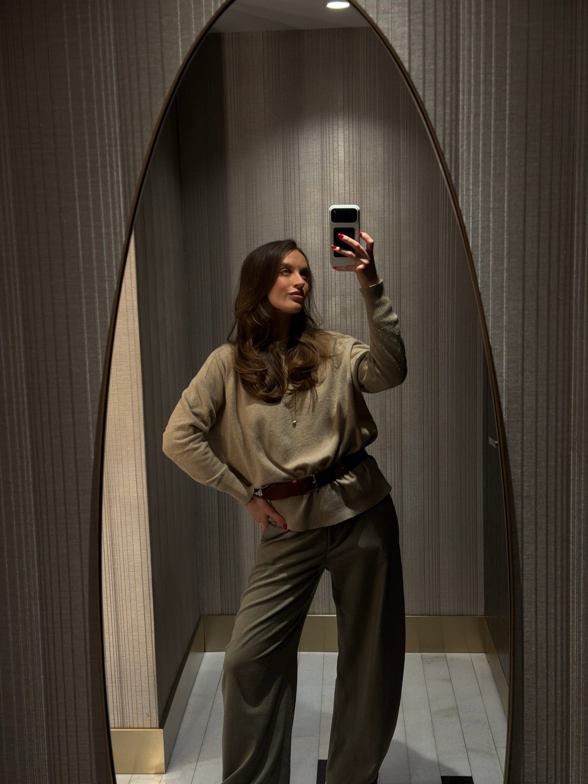 Woman takes mirror selfies in Budva bathroom