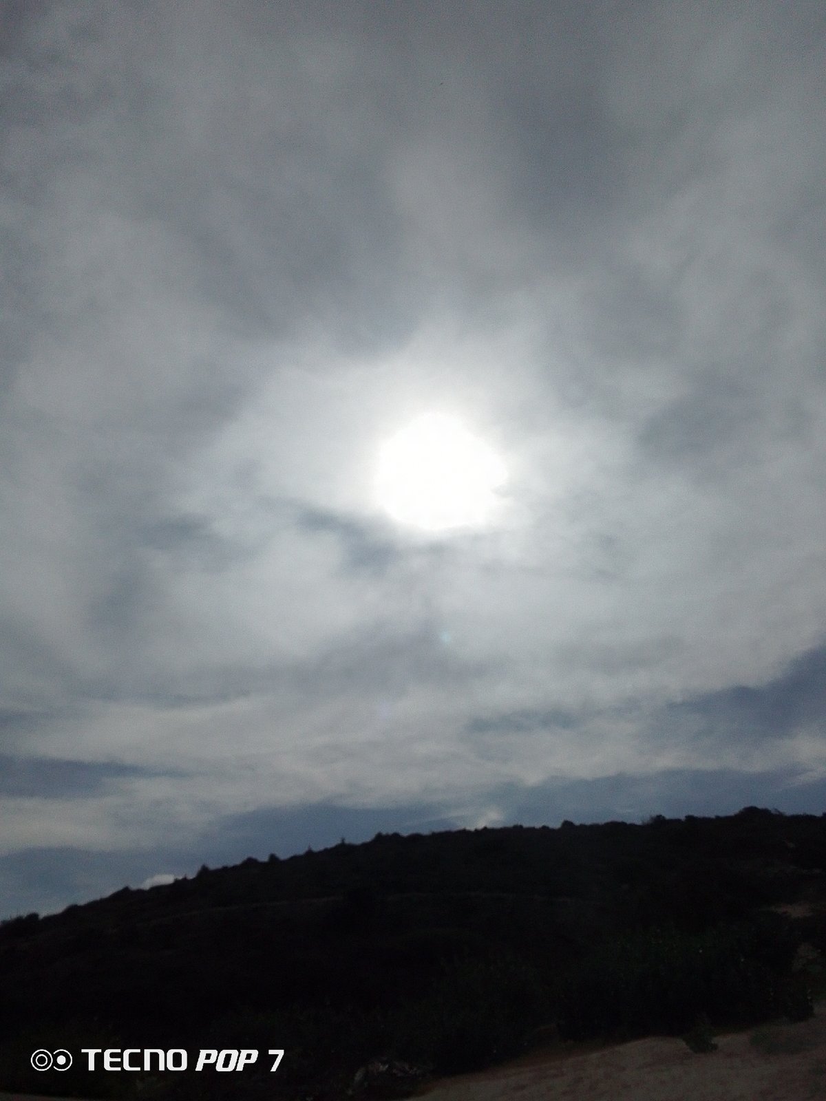 Sunlight breaks through overcast sky over Venezuelan landscape