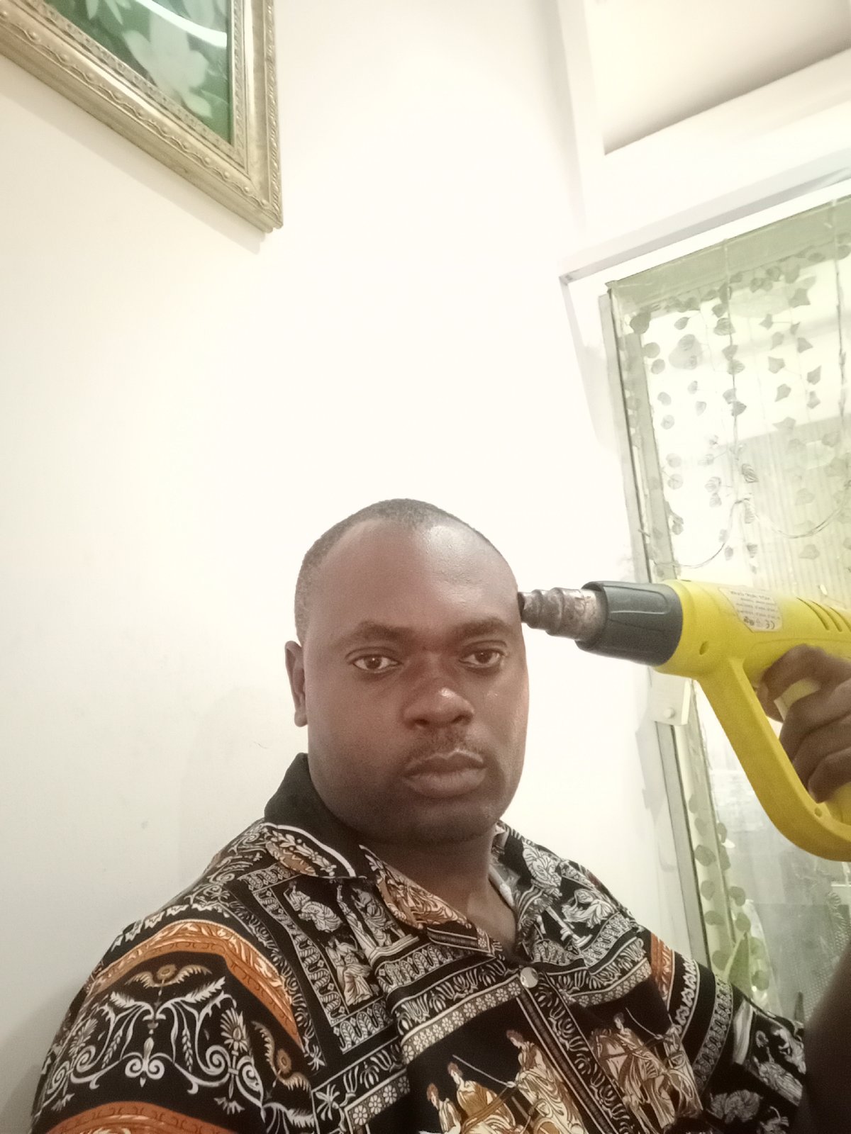 Man photographed with heat gun in Gwarinpa, Nigeria