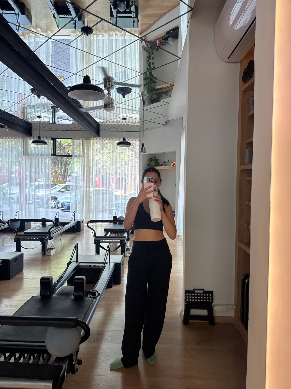 Woman takes selfie at Tres Pilates Studio in Puebla