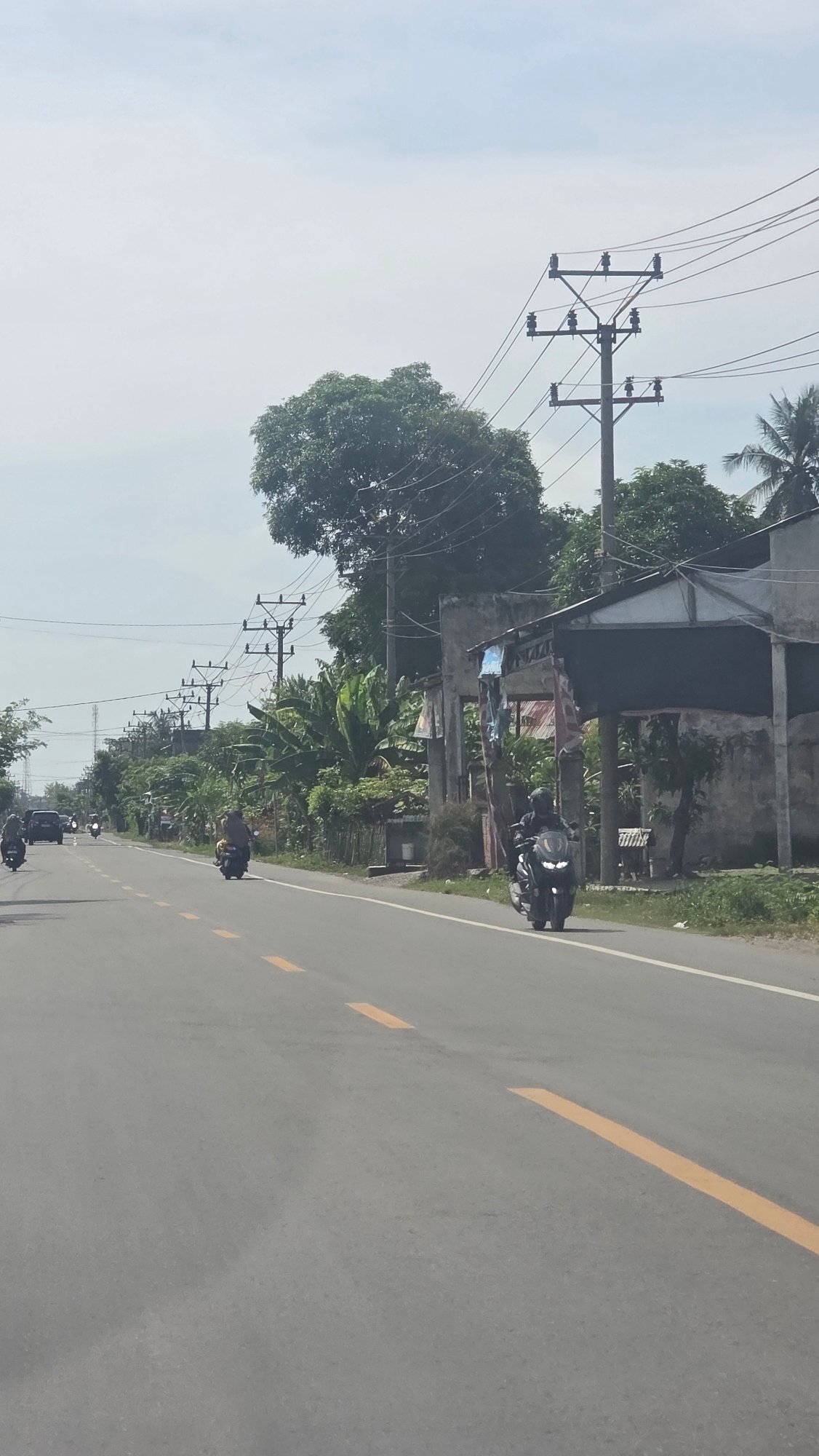 Morning traffic flows on main road in Teungoh Baro