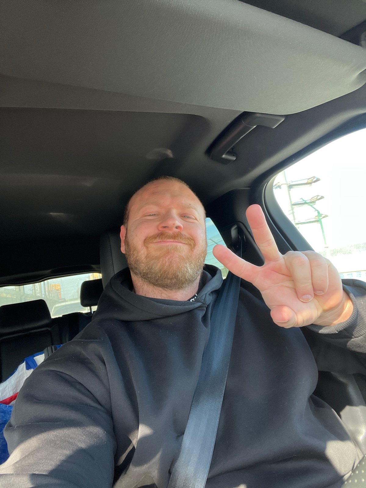 Driver smiles for camera in Chaikovsky vehicle