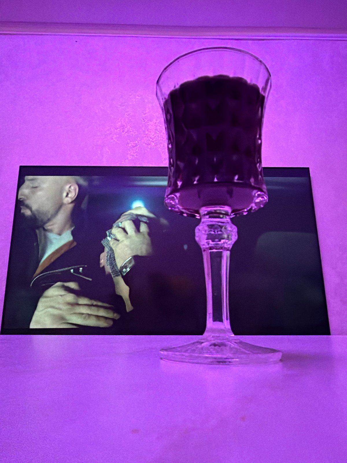Evening at a purple-lit Kyiv bar with beer and TV