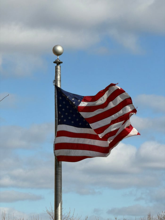 American flag flies on New York flagpole amid winter afternoon