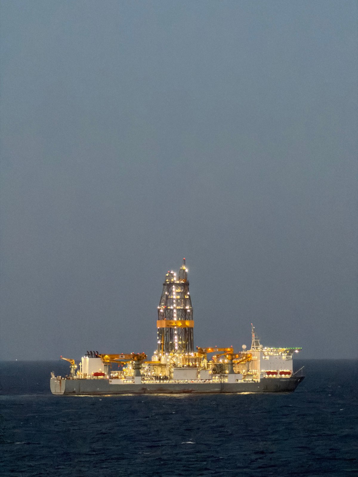 Offshore drilling platform spotted at sea during dawn hours