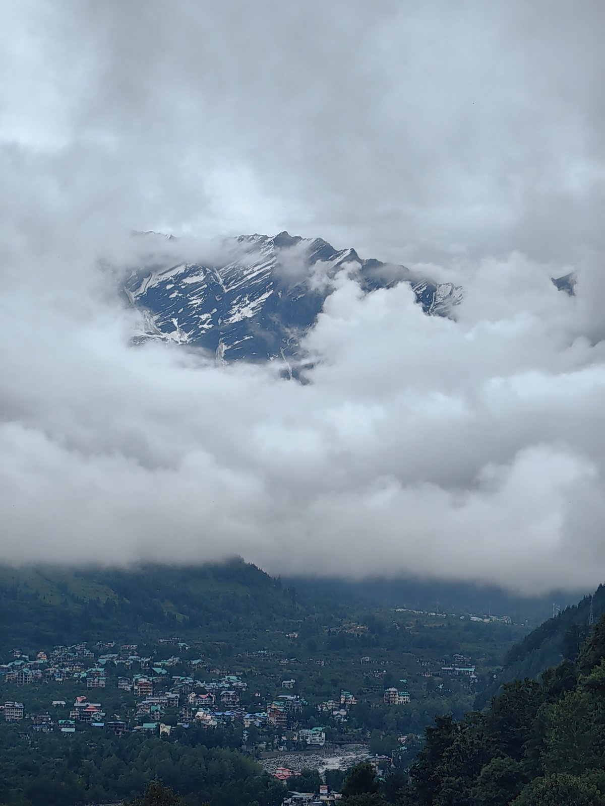 Vashisht village and Himalayan peaks on a foggy morning