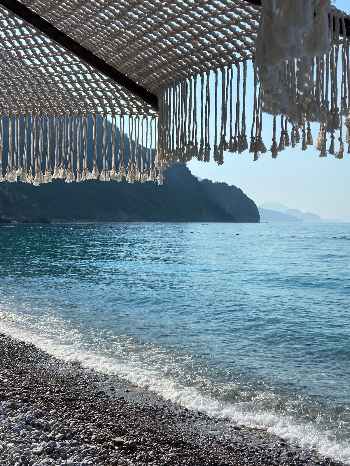 Quiet morning at a pebble beach resort on the Montenegrin coast