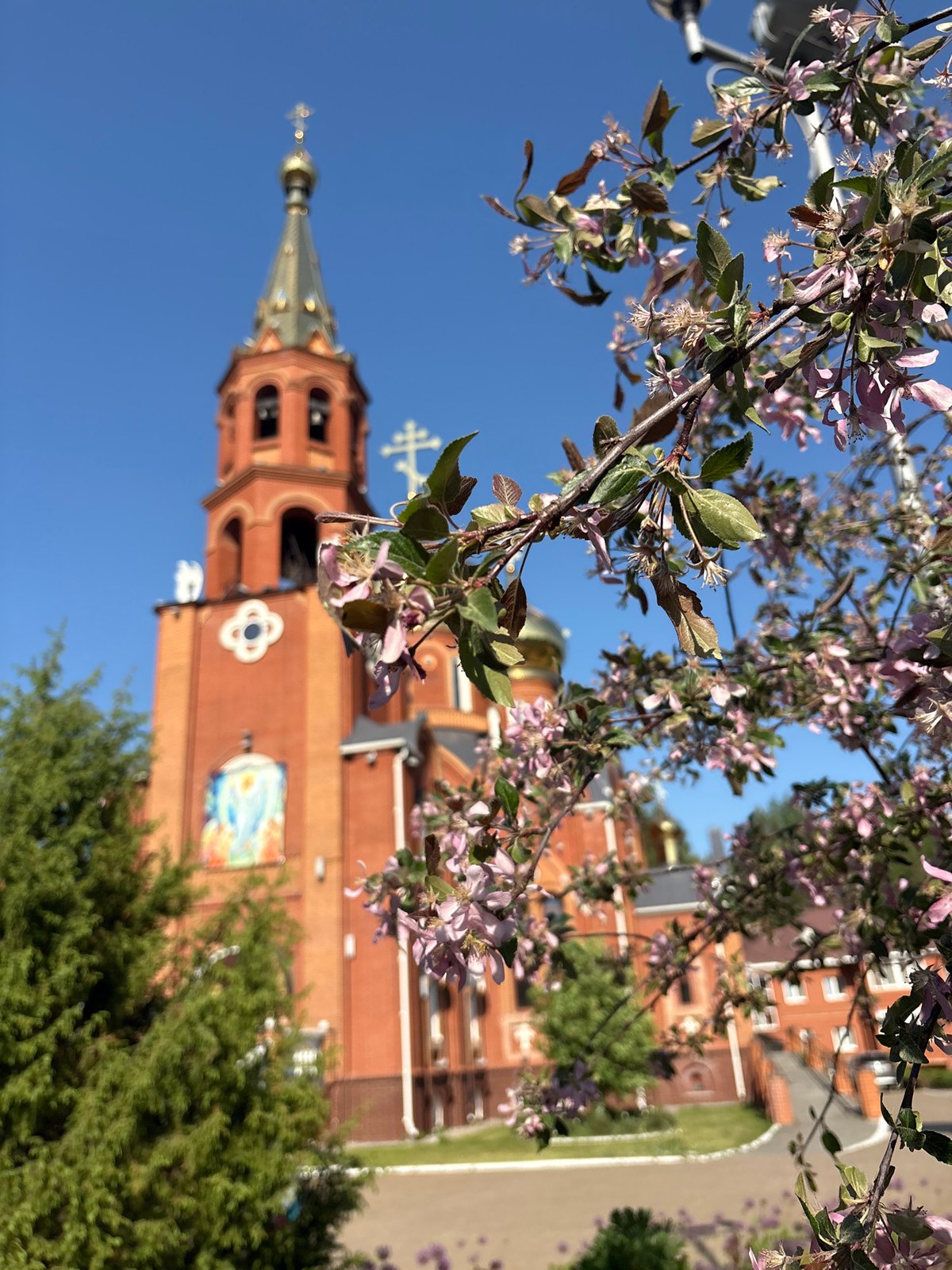 Church photographed amid spring blossoms in Chaikovsky, Russia