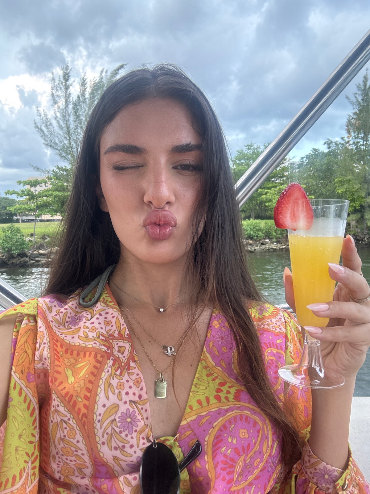 Boat party with cocktails on Biscayne Bay, Miami skyline backdrop