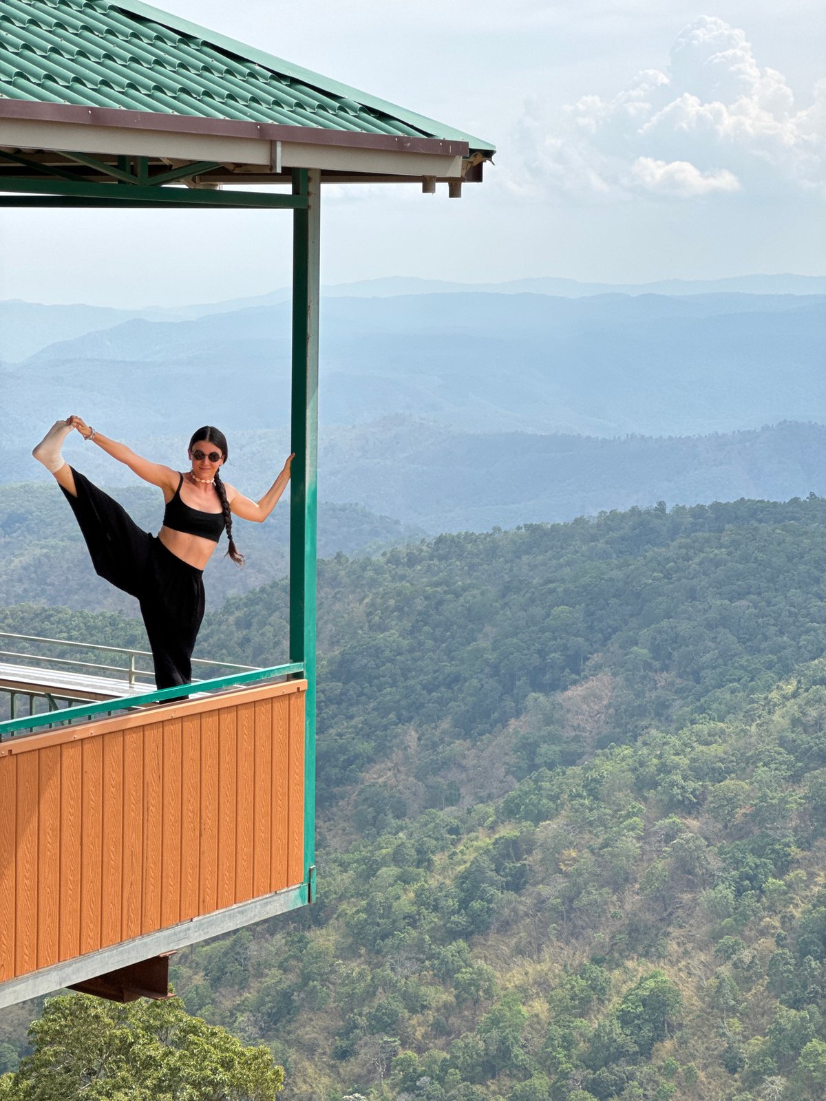 Woman performs acrobatics on building structure in Vietnam