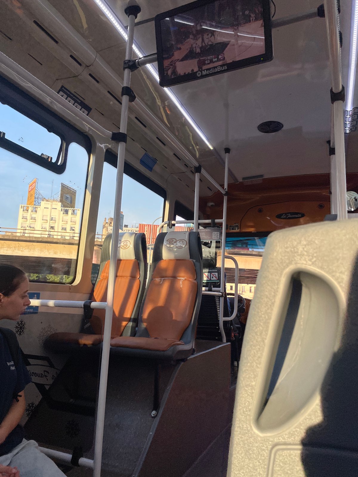 Bus passenger observes Buenos Aires cityscape through window