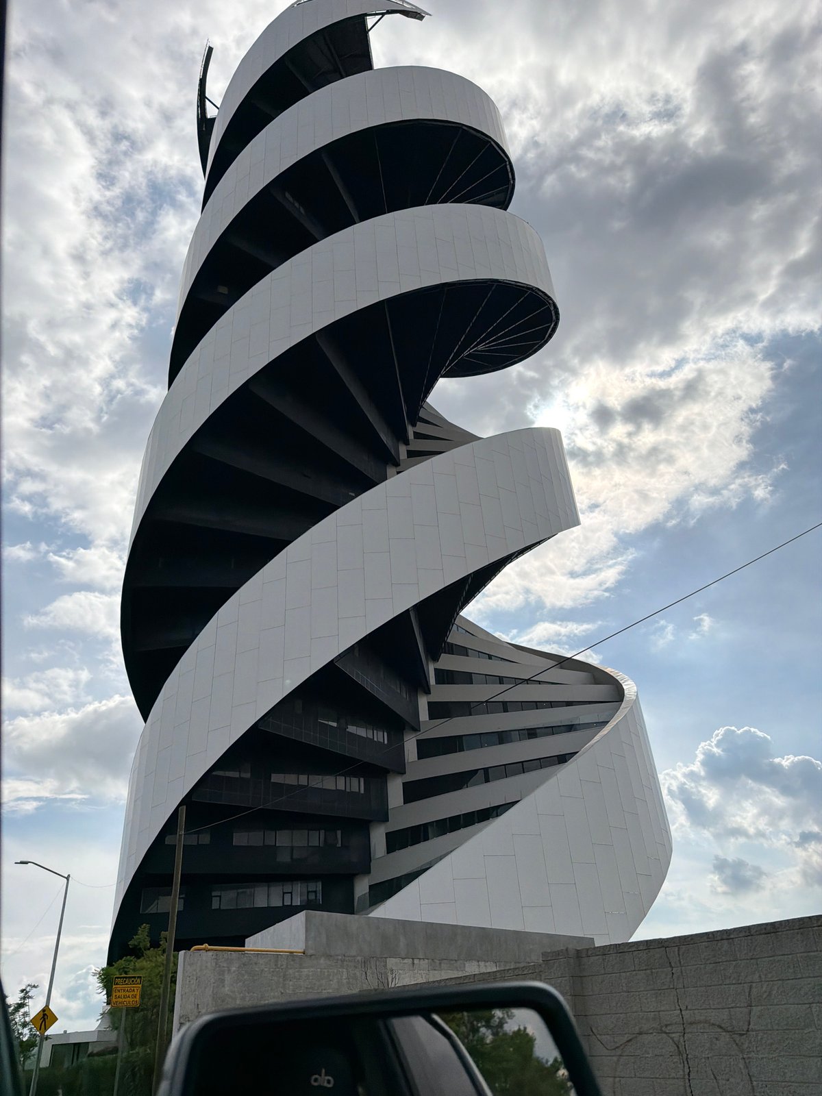 Modern spiral building observed from vehicle in Tlaxcalancingo, Mexico