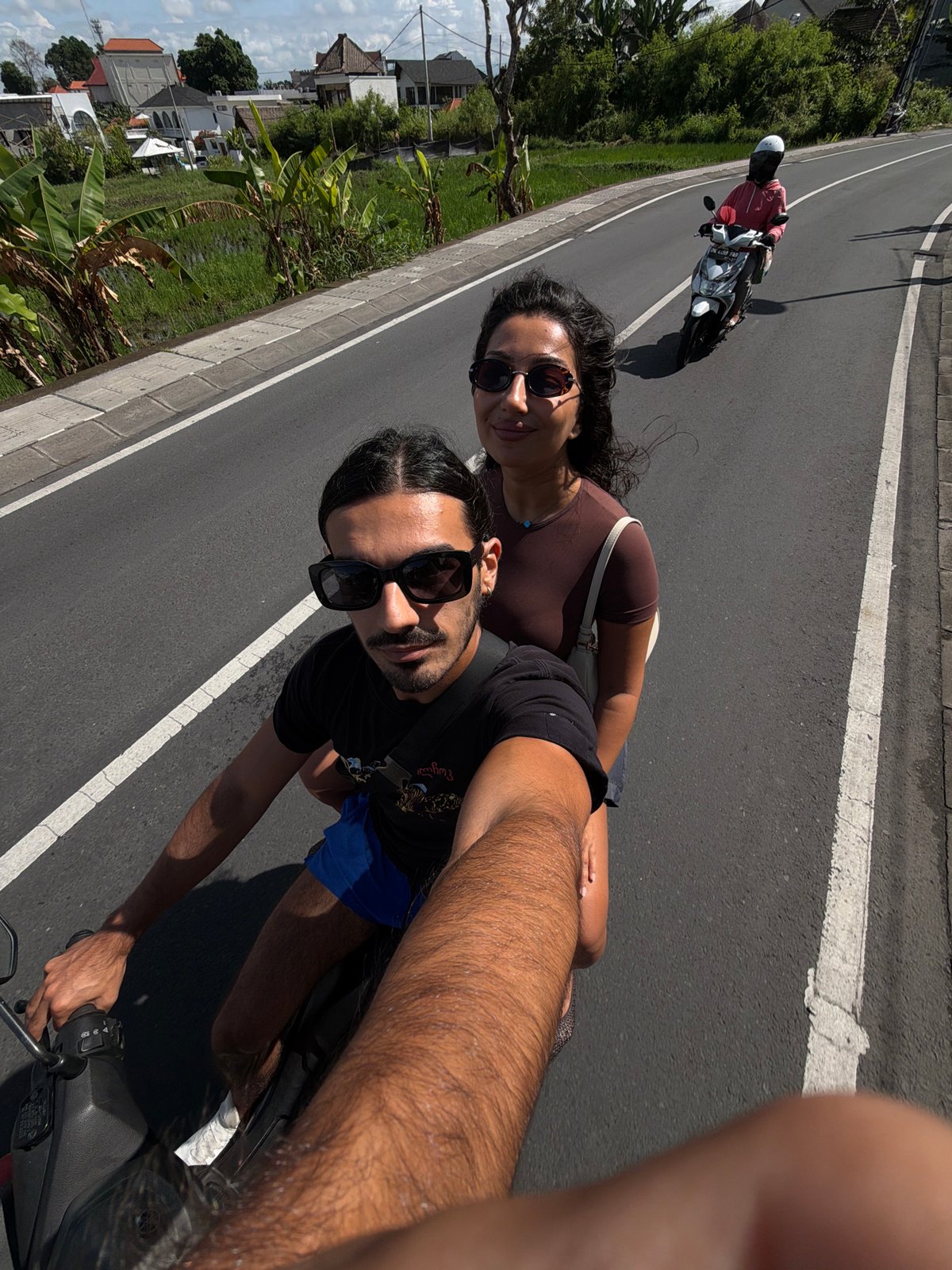 Couple films scooter ride selfies in North Kuta
