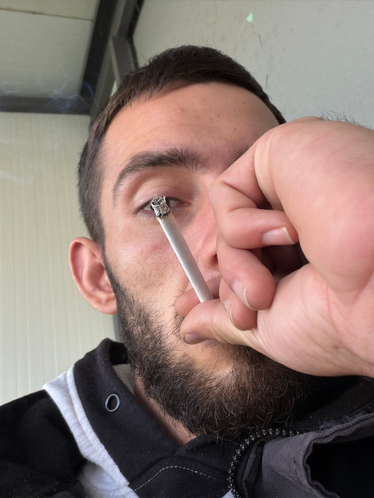 Man photographed smoking indoors in Bulgarian village morning