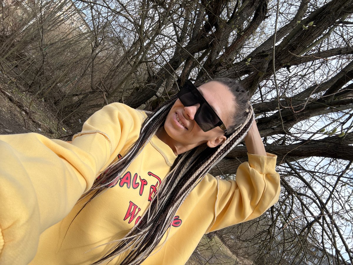 Woman in yellow sweatshirt photographed outdoors in Rusanovo
