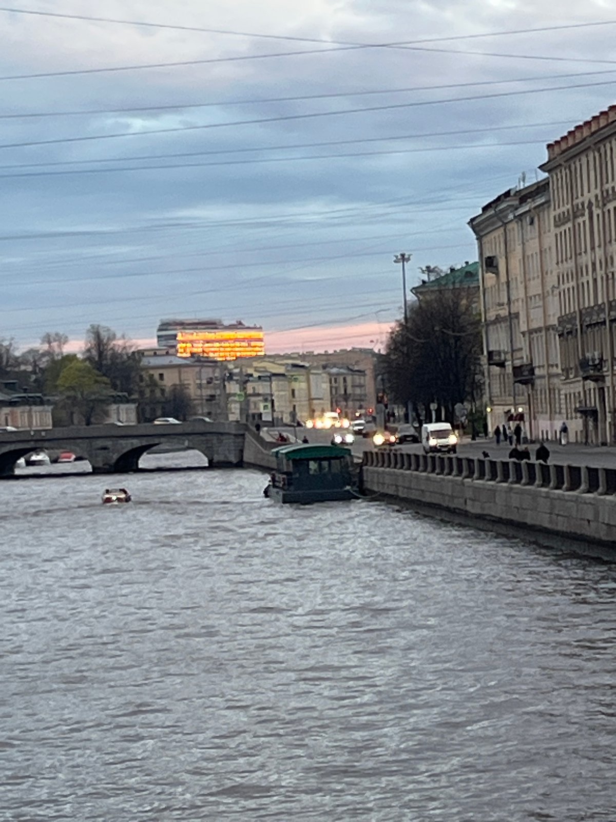 Small boat travels Griboyedov Canal in Saint Petersburg