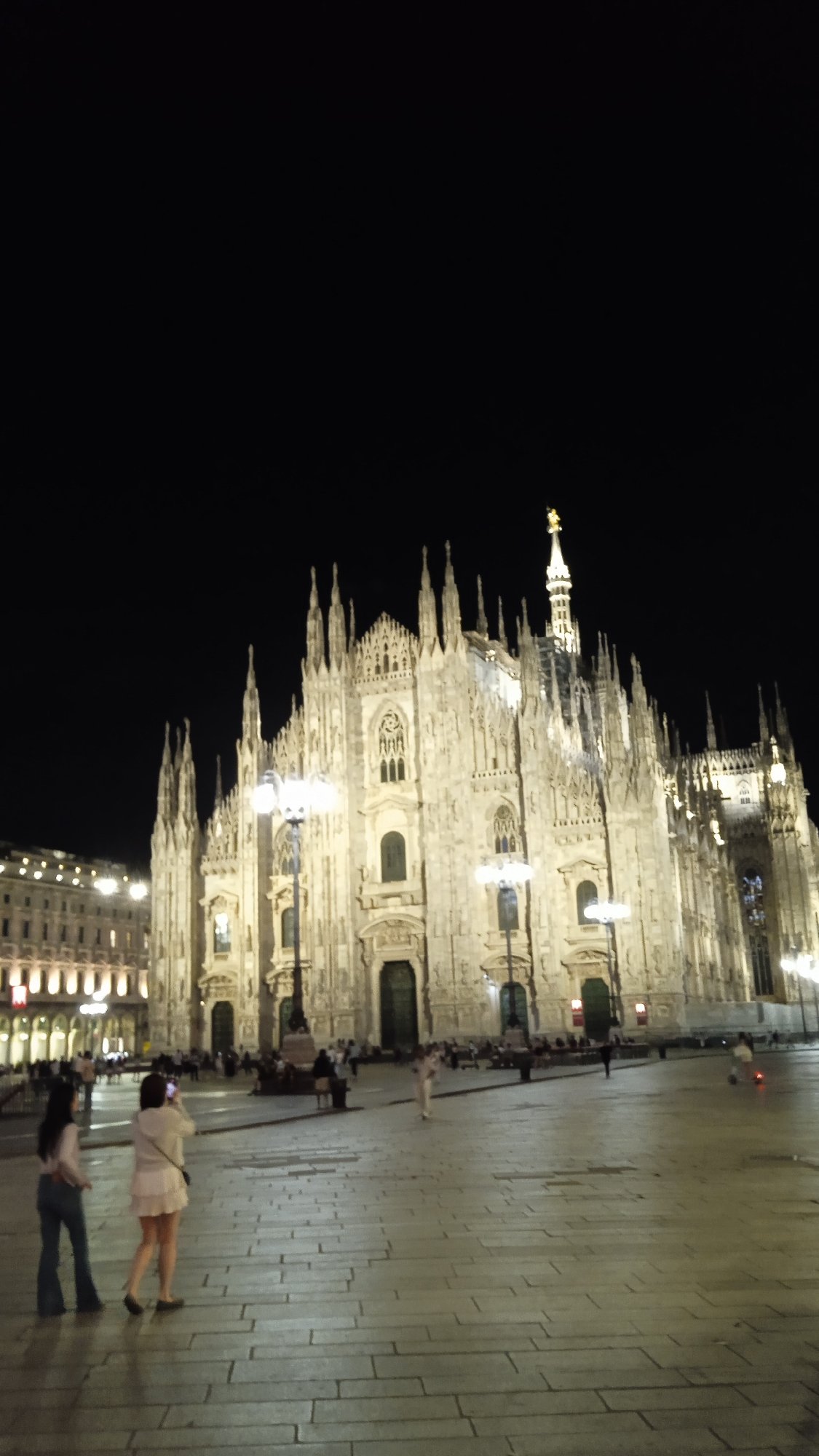 Milan's Duomo glowing at night, piazza level