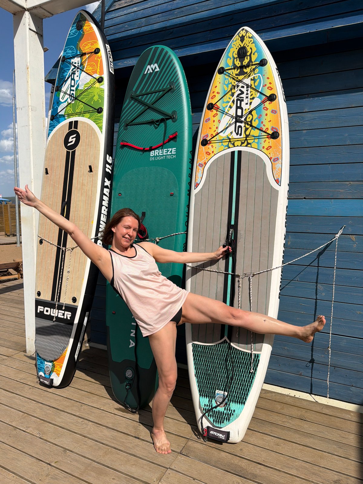Woman enjoys paddleboarding session on calm waters in Chaikovsky