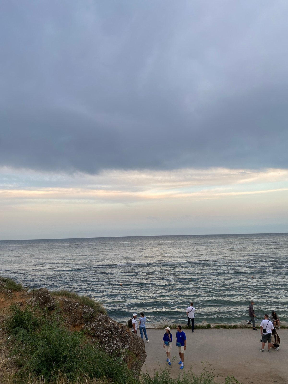 Waterfront at dusk: cliffs, coastline, and urban edges