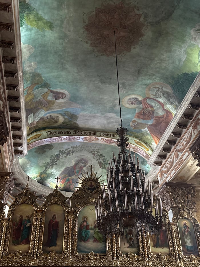 Visitor documents ornate Russian Orthodox monastery and resident cats