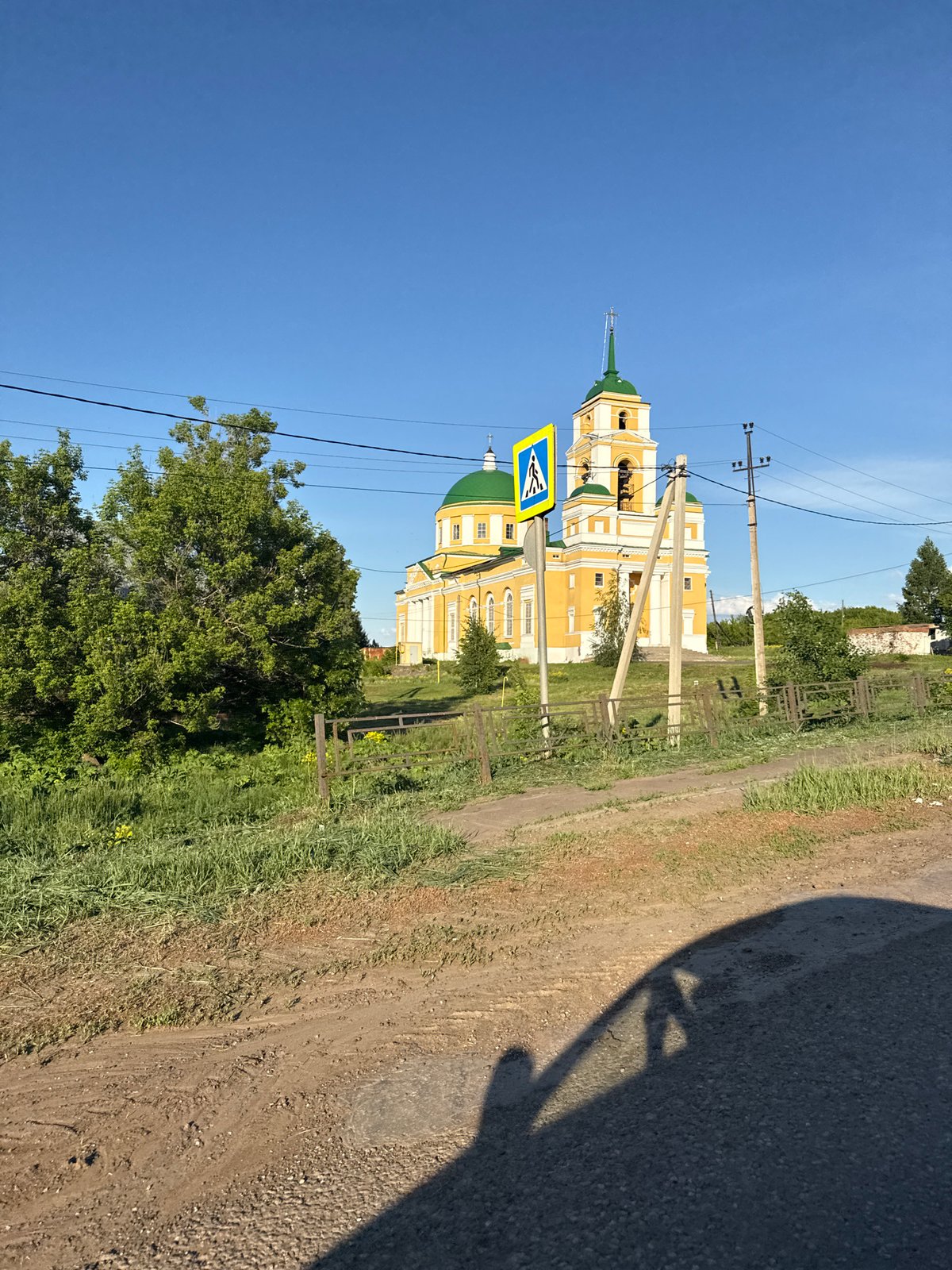 Sunny drive past church in rural Мазунино, Russia