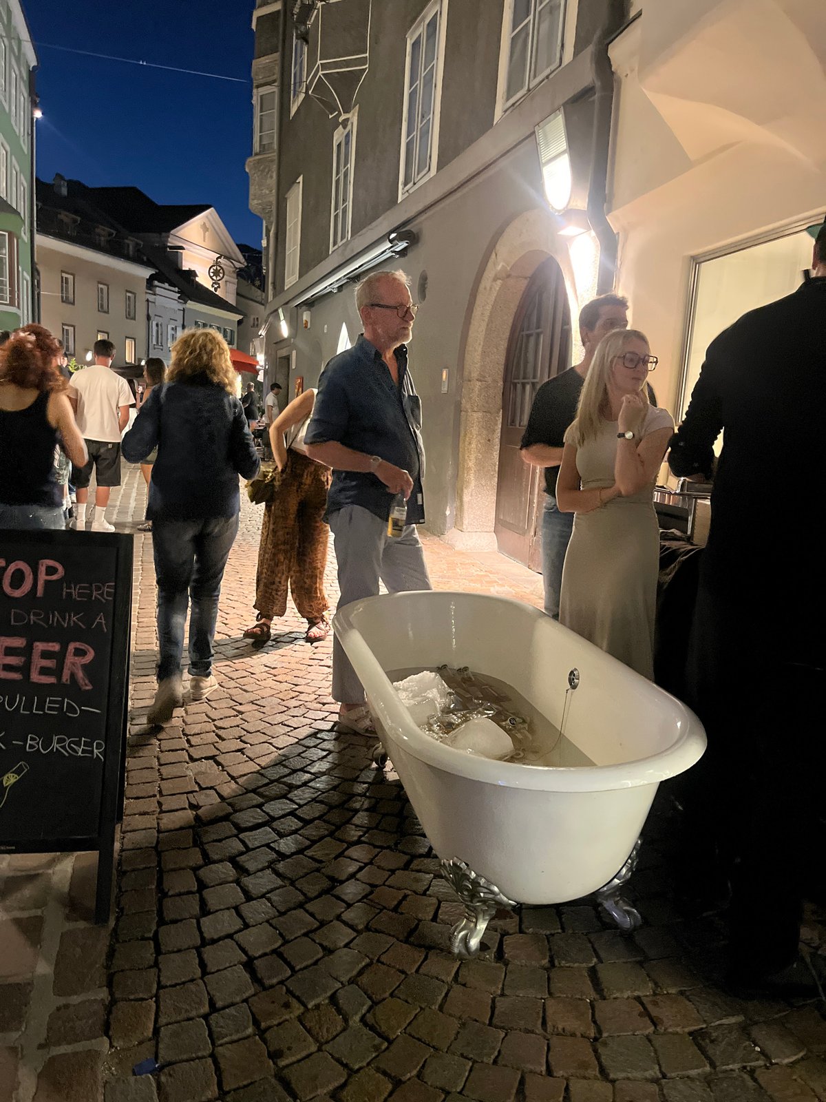 Ice-filled bathtub on cobblestone streets of Bressanone at dusk