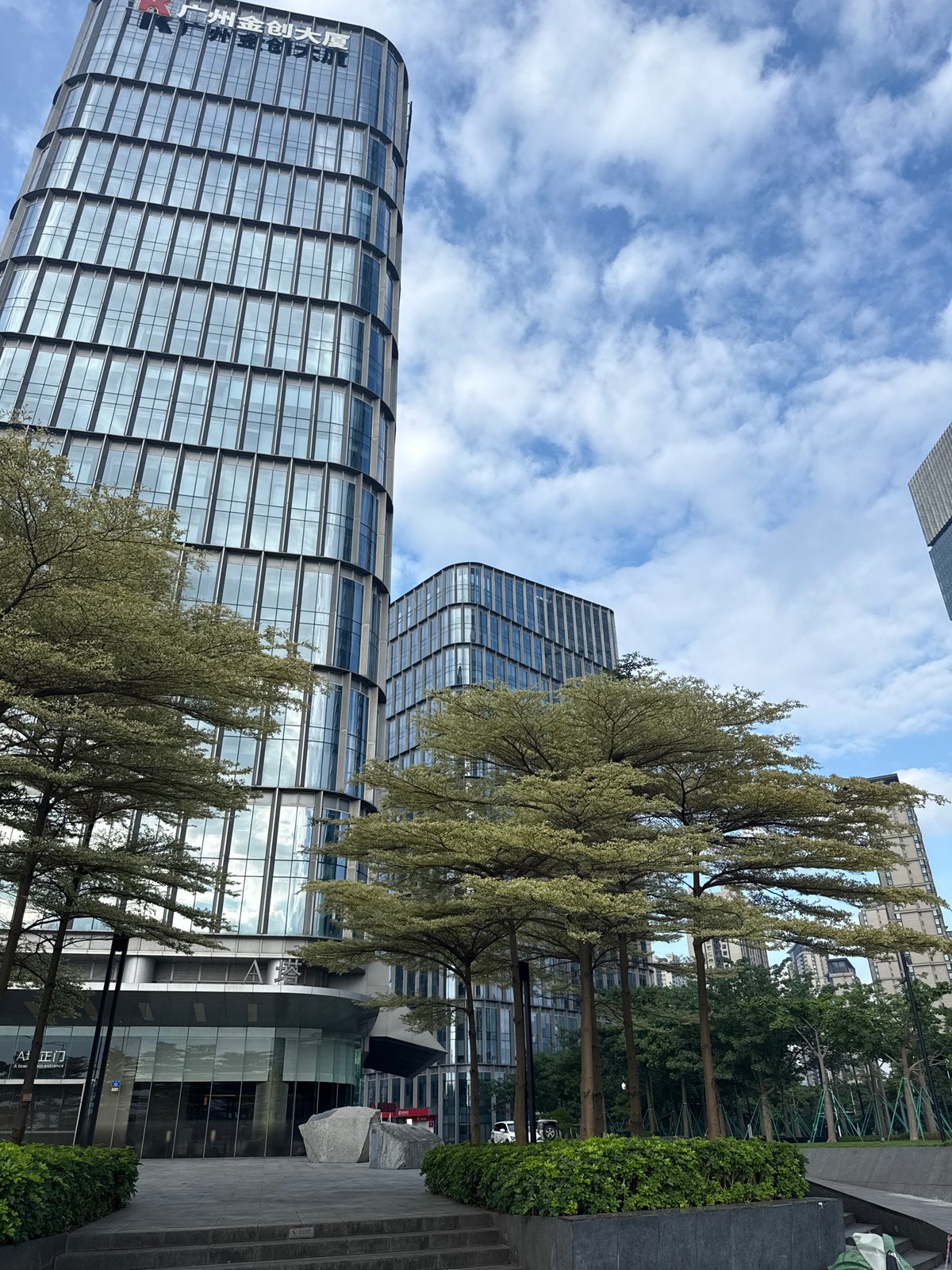 Street-level scenes around Haizhu District's glass tower precinct