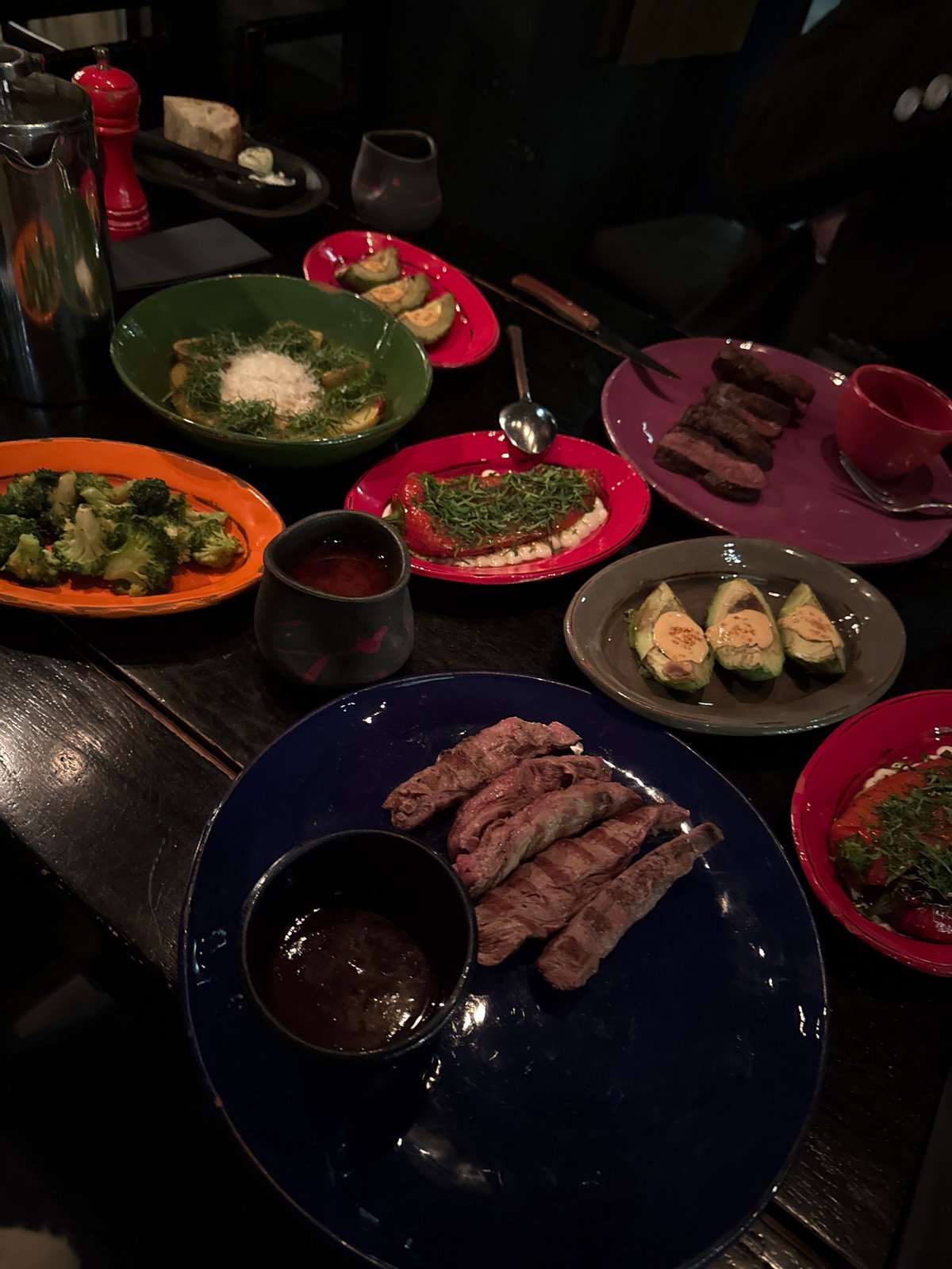 Candlelit dinner documented at Moscow restaurant featuring colorful plates
