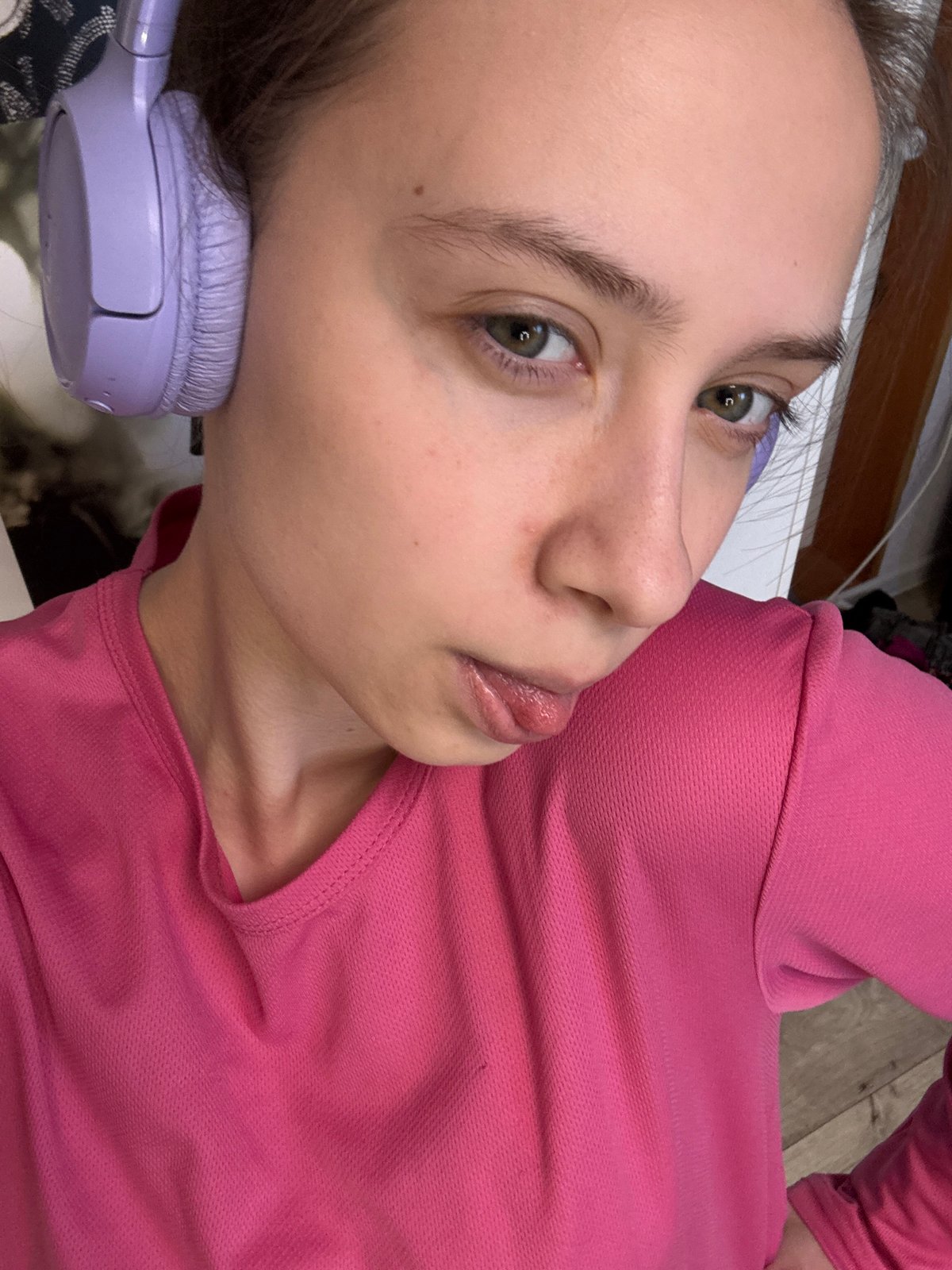 Woman in pink top photographed with purple headphones in Russia