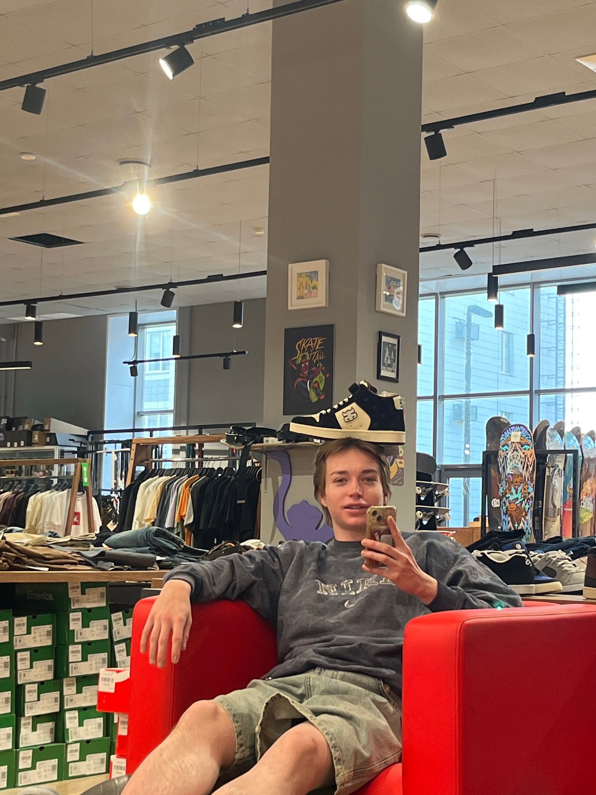 Person takes selfie in red chair at Krasnoyarsk retail store