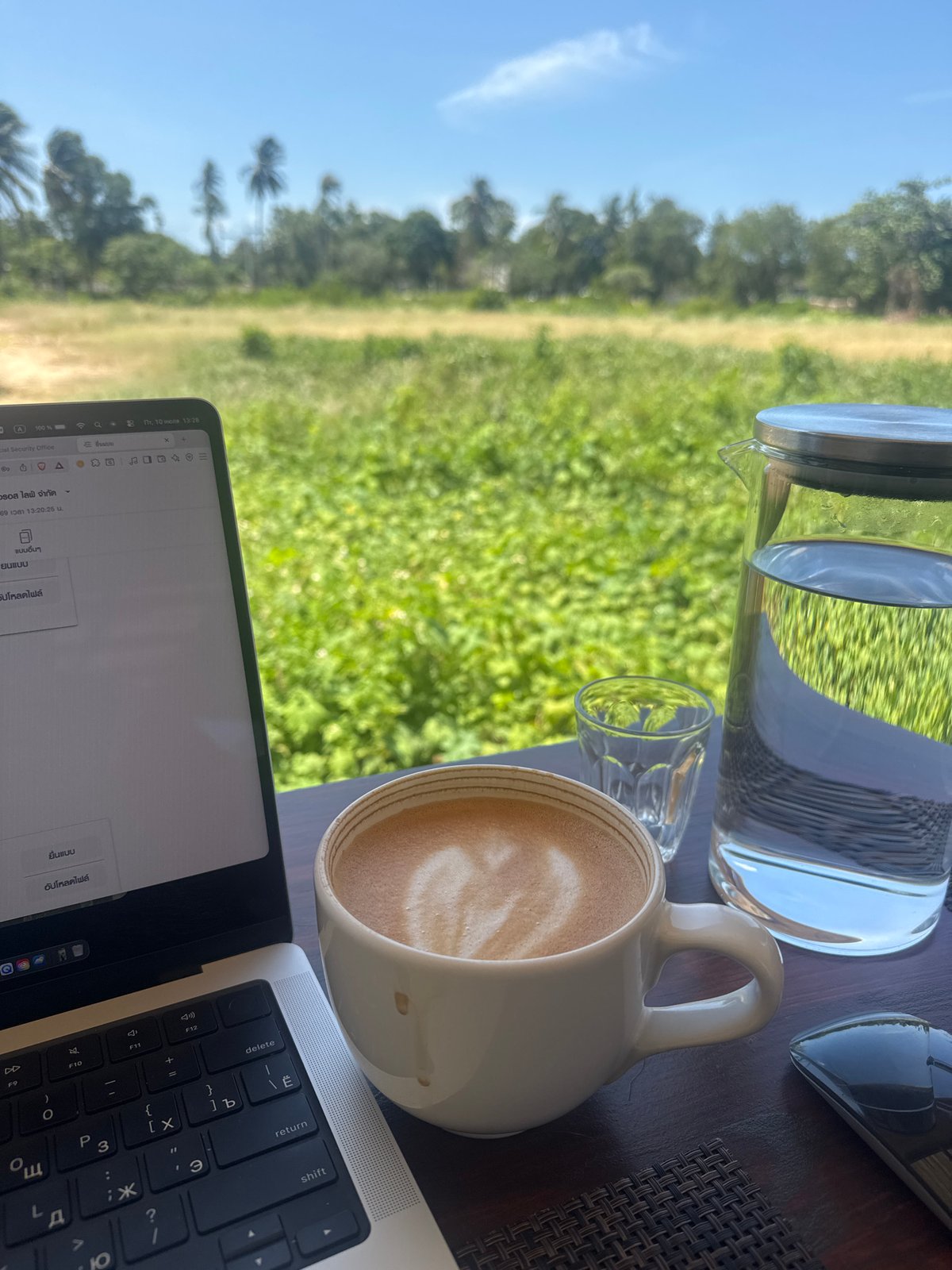 Laptop and coffee on a woven mat in Ko Samui