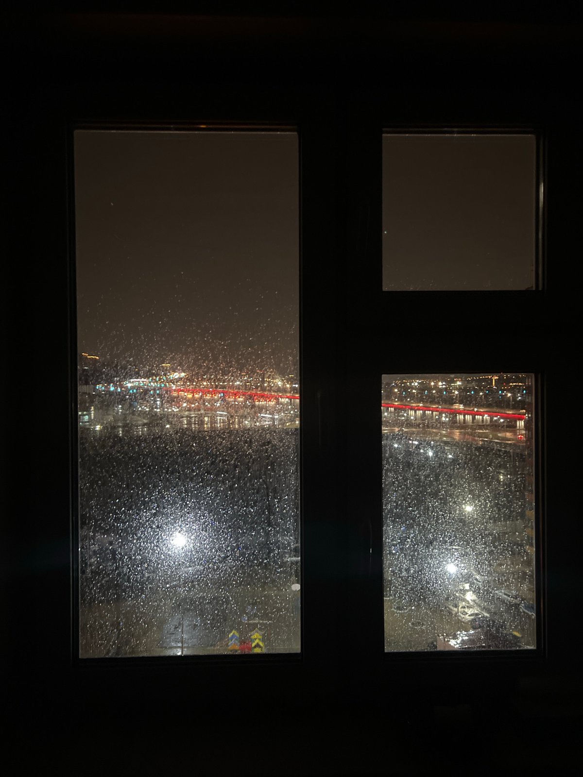 Rainy evening views captured through windows in Krasnoyarsk