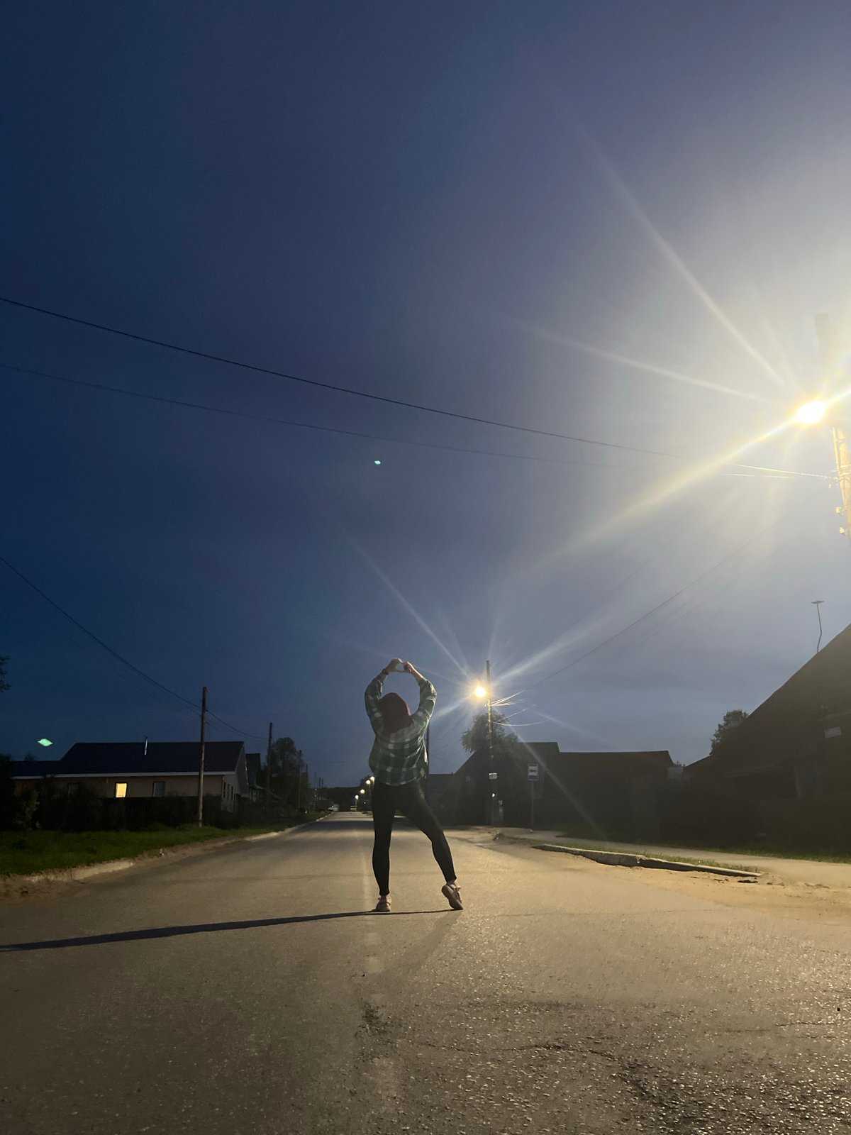Woman poses on road in Chaikovsky, Russia