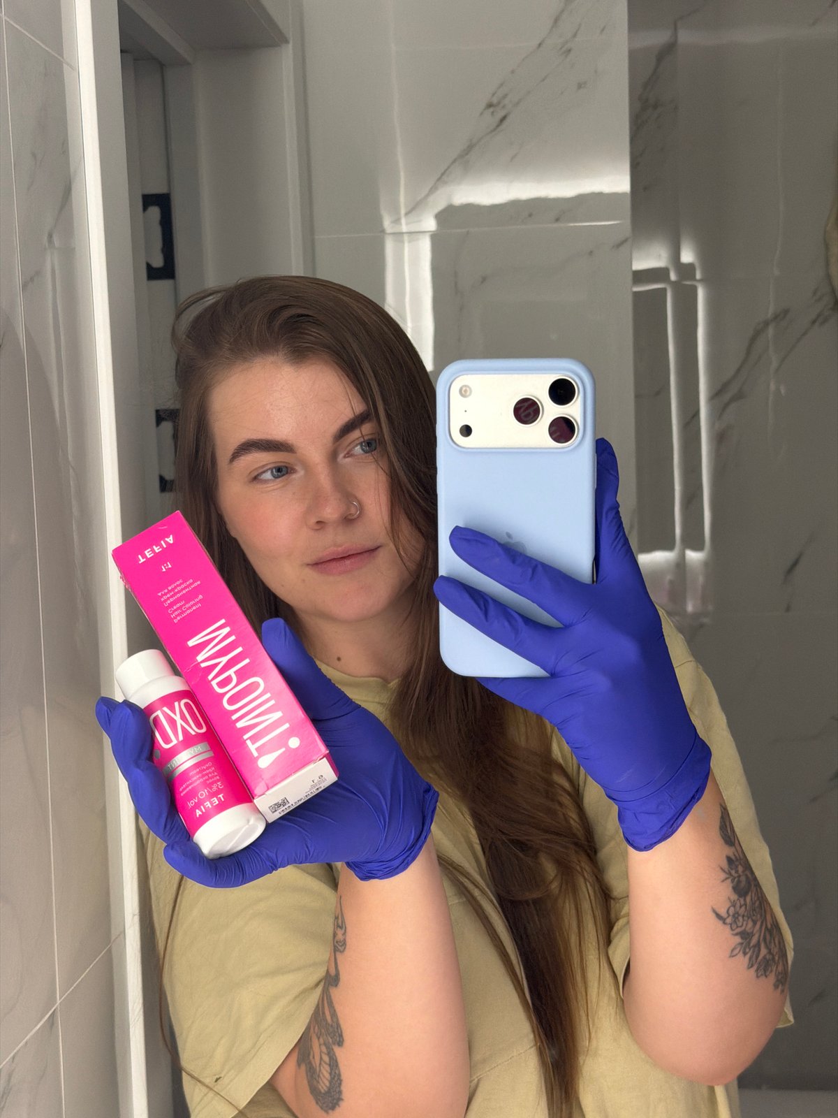 Person documents hair dyeing session in Russian bathroom selfies