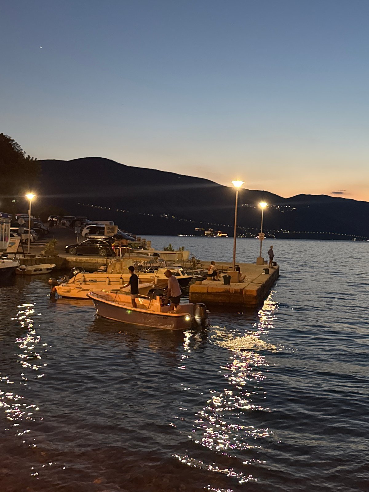 Boats at rest on calm water as dusk settles in