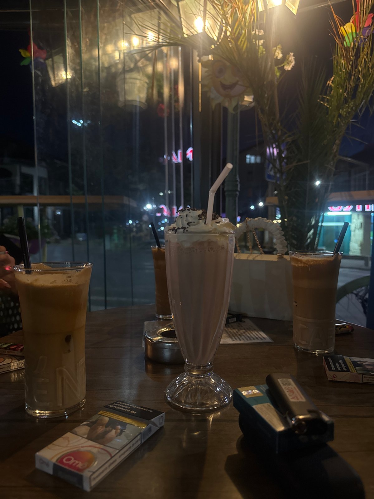 Outdoor cafe table setting with beverages observed