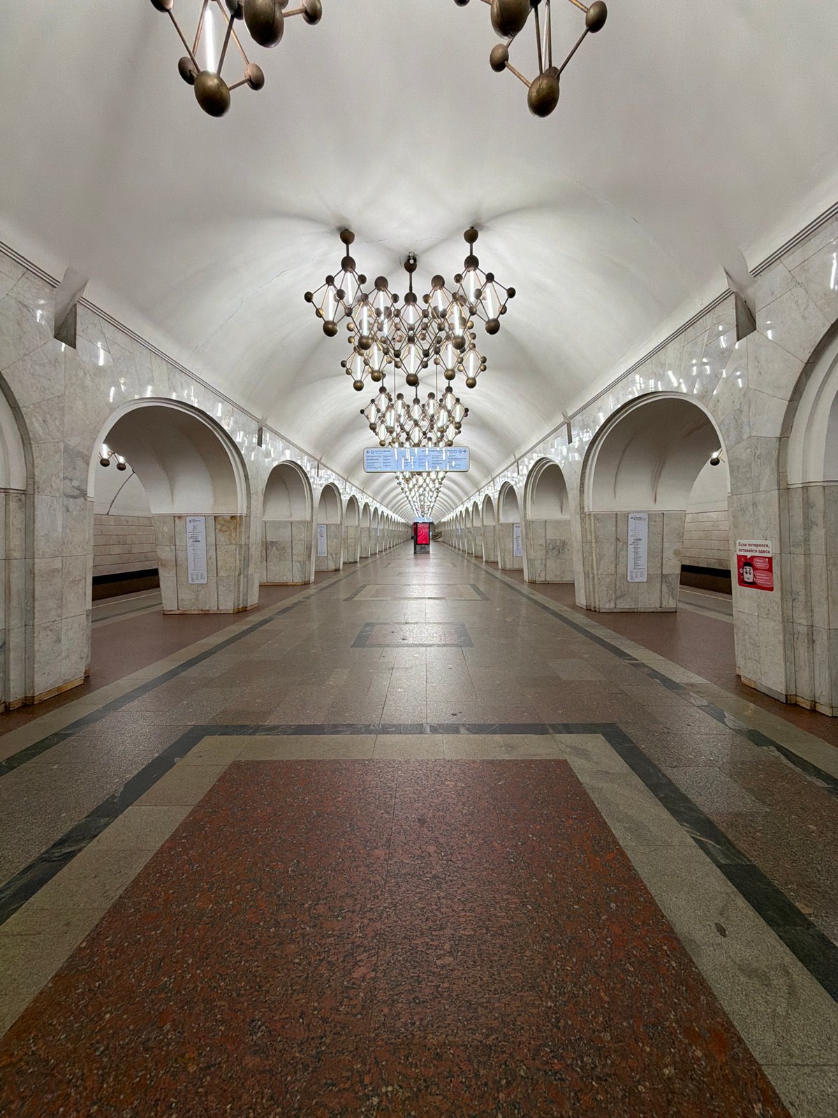 Ornate subway station hall with bronze chandeliers documented