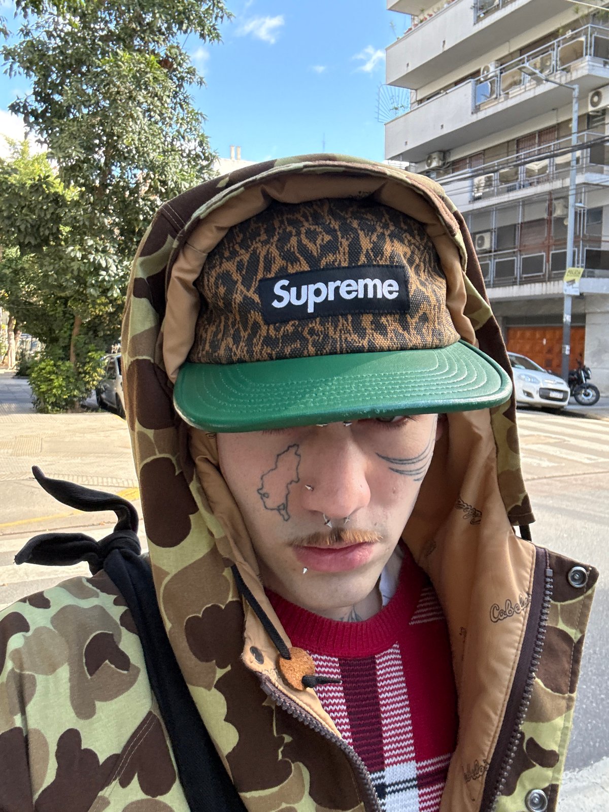 Person in Supreme hat, camo jacket spotted in Buenos Aires